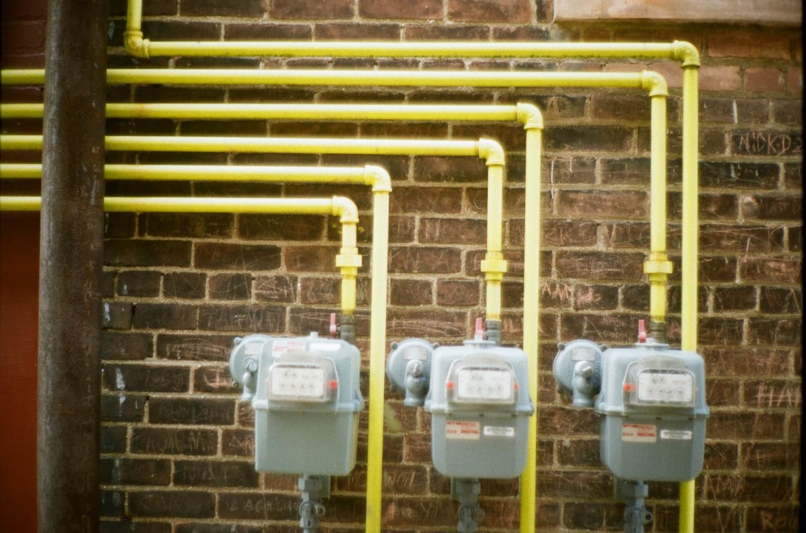 Pipes in front of brick wall